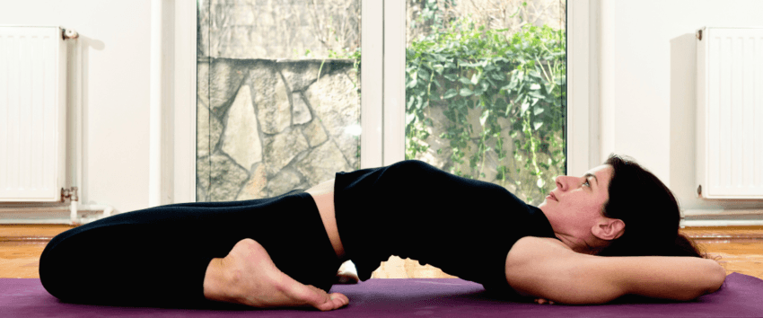 a girl practicing yoga on a mat