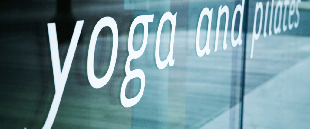 a glass door writing yoga and pilates